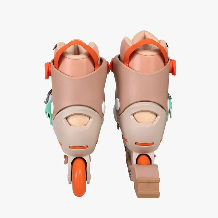 Pair of beige and orange roller skates on a white background