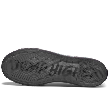 Black sole of a sneaker on a white background, with “Jump Higher” printed on the sole.