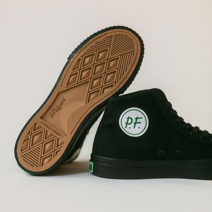 Black high-top sneakers with the green P.F Flyers logo on a light gray background