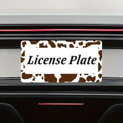 2D Flat Design, Single Piece, For Decorative Purposes Only, Featuring A Cow Pattern License Plate Frame With An Attractive Animal Design On A White Background, Complete With Black Spots.This Car Decor