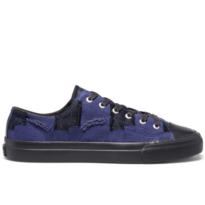 Blue sneaker with black sole on a white background