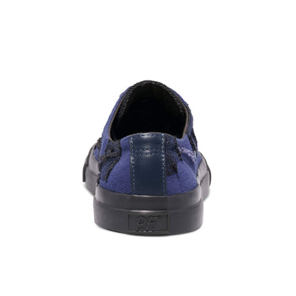 Blue slip-on sneaker with a black sole on a white background