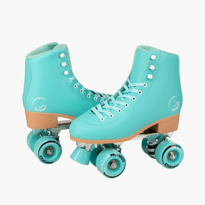 Pair of turquoise roller skates with wooden soles on a white background