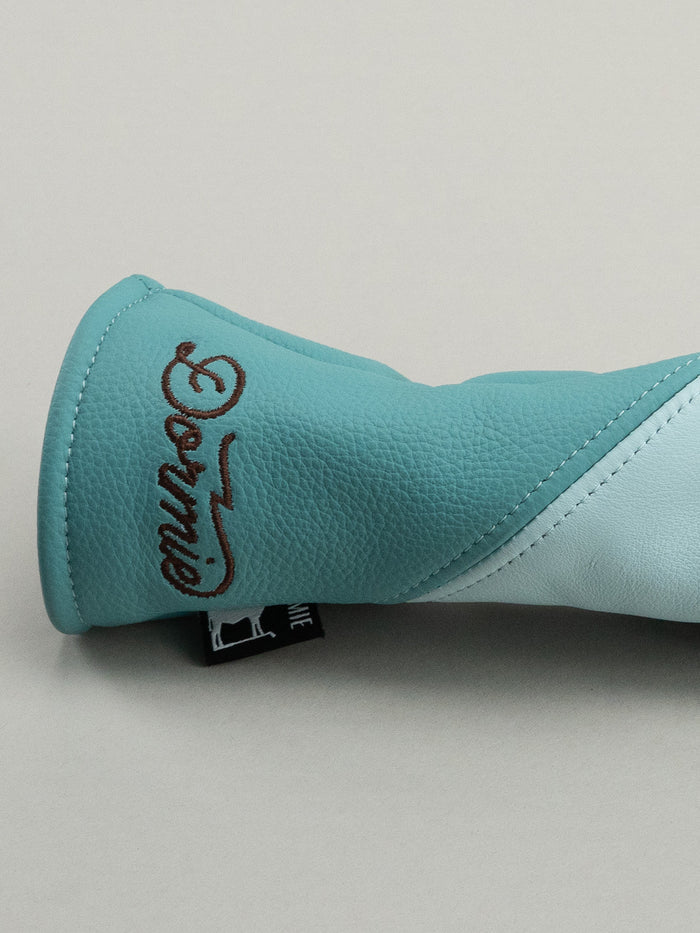 Light blue golf club head cover with a floral design and 'Dormie' branding