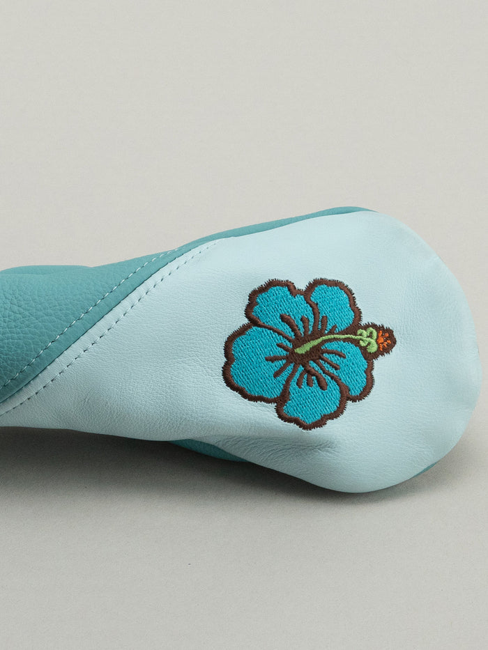 Light blue golf club head cover with a floral design and 'Dormie' branding