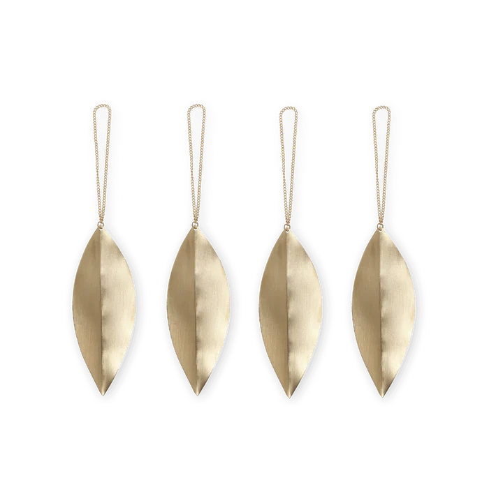 Four brass leaf-shaped ornaments with strings on a white background