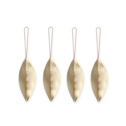 Four brass leaf-shaped ornaments with strings on a white background