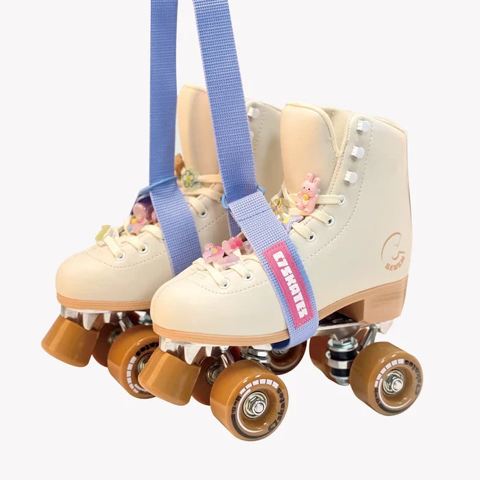 Pair of beige roller skates with blue straps featuring the brand 'C7Skates' on a white background