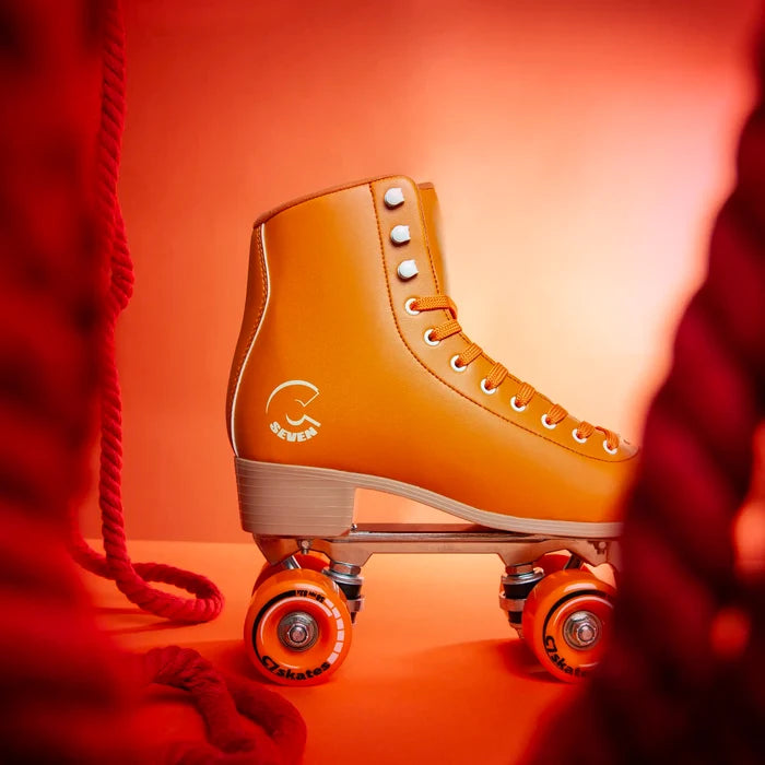 Orange roller skate with orange wheels on a red background featuring the brand 'C7Skates'