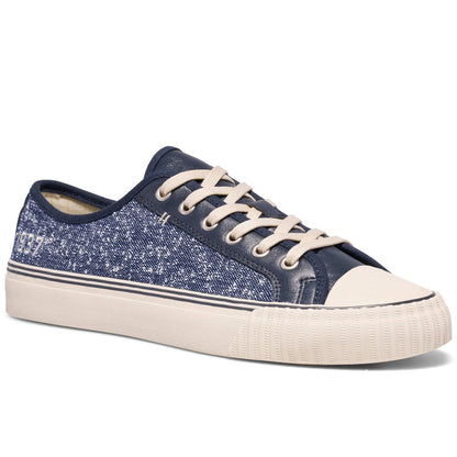 Navy blue denim sneaker with white laces on a white background