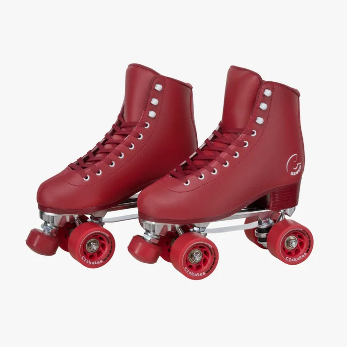 Red roller skates with white laces on a white background