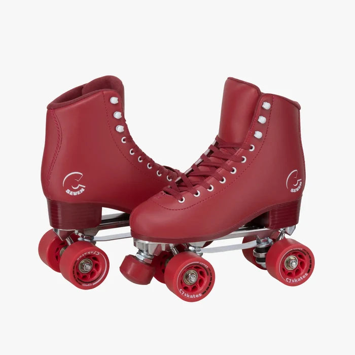 Red roller skates with white laces on a white background