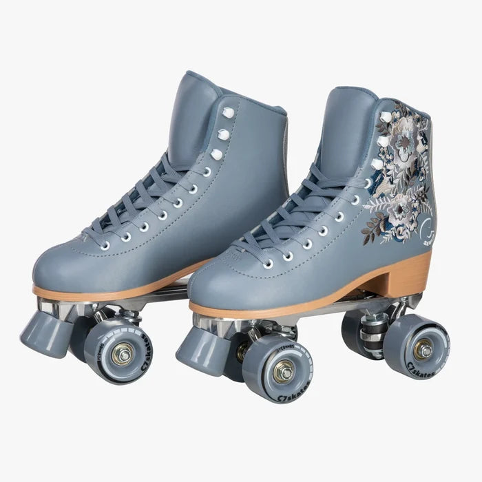 Pair of blue roller skates with floral design on a white background