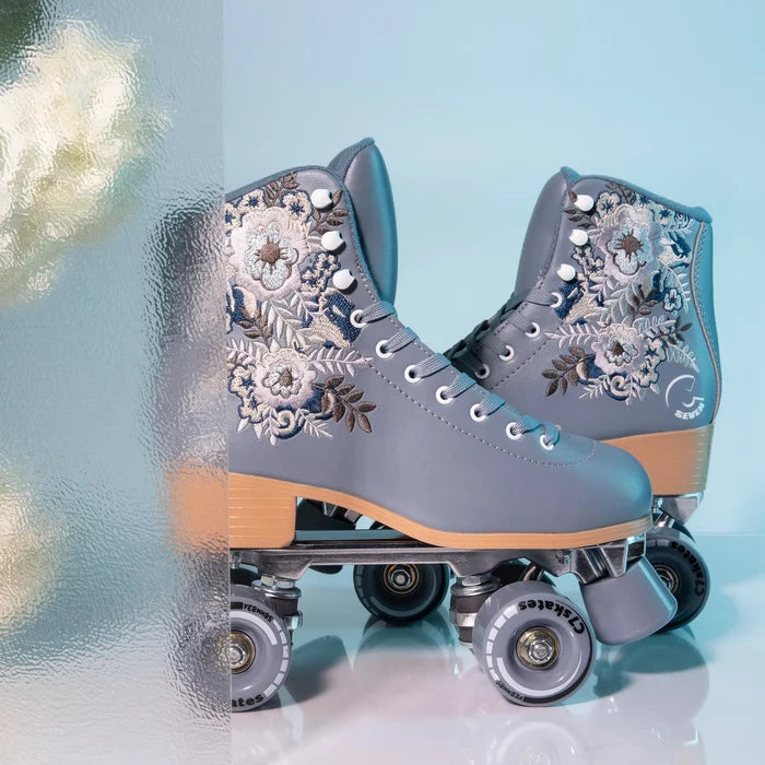 Gray floral-patterned roller skates on a light blue background