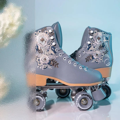Gray floral-patterned roller skates on a light blue background