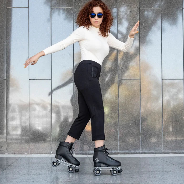 Woman roller skating in front of a textured wall