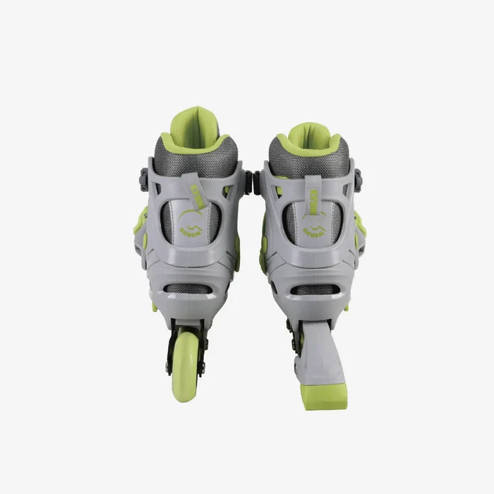Pair of gray and green inline skates on a white background