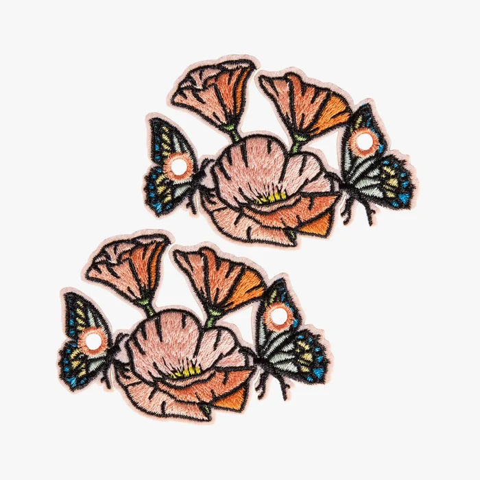 Two floral and butterfly charm on a white background