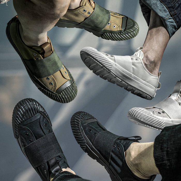 Four pairs of shoes in different colors and styles on a reflective surface.