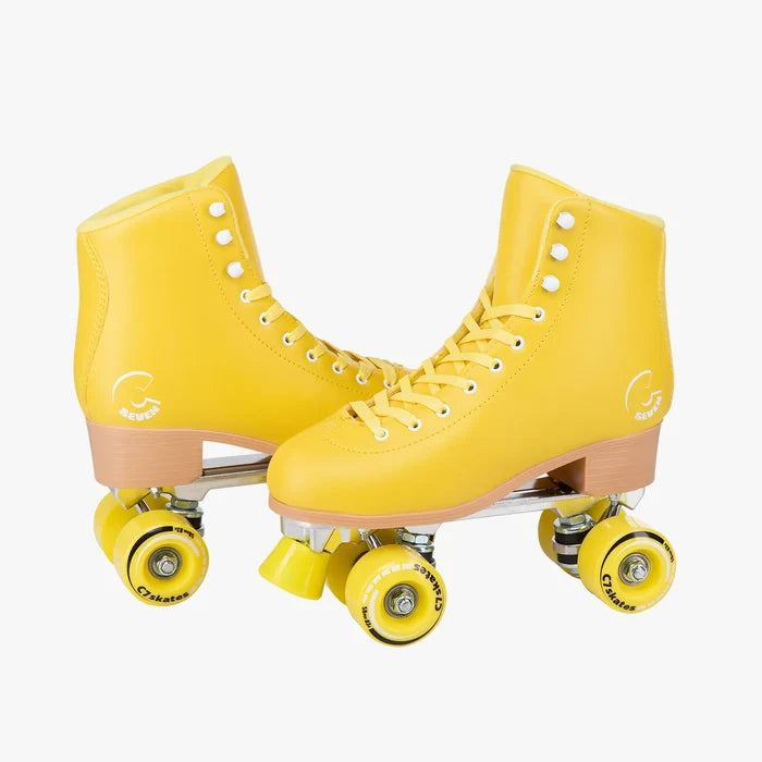Pair of yellow roller skates on a white background
