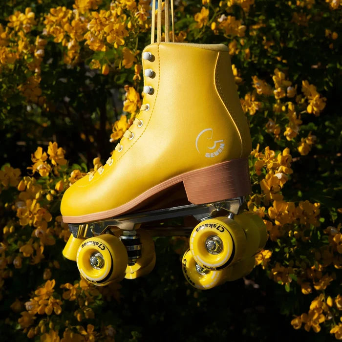 Yellow roller skate with visible brand logo against a floral background