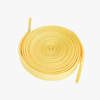 Yellow shoelaces coiled on a white background