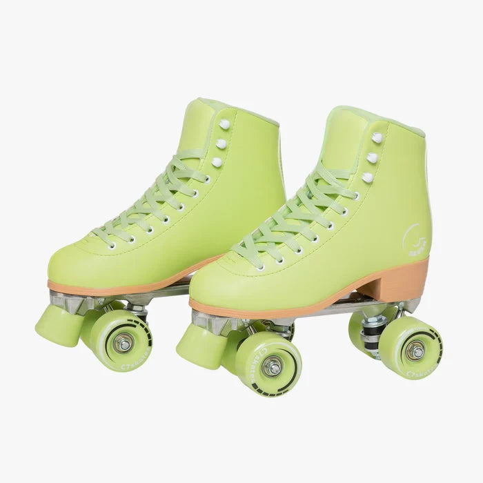 Pair of neon green roller skates with white laces on a white background
