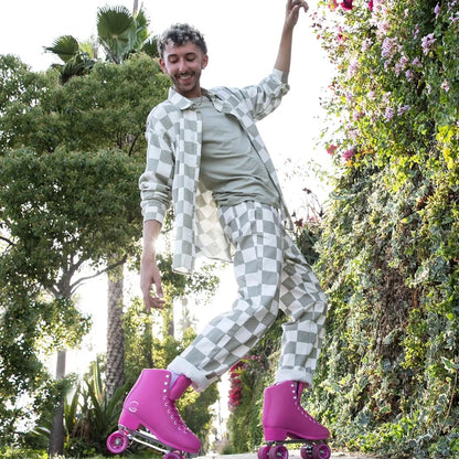 Person rollerblading in a park with greenery and flowers in the background