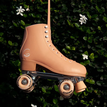 Tan roller skate on a green leafy background