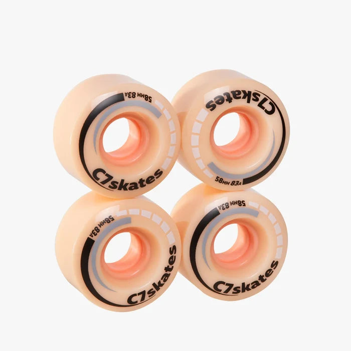 Four peach C7skates wheels on a white background