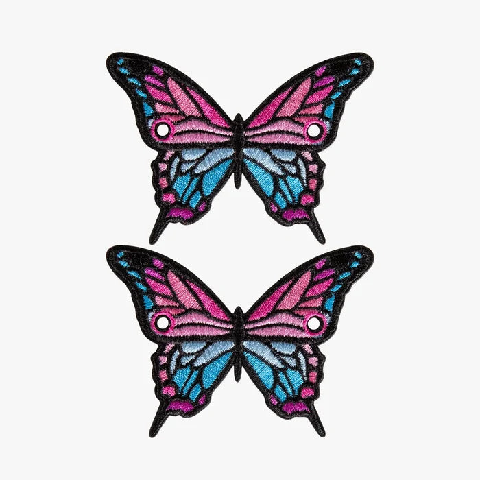 Two butterfly-shaped charms with pink and blue wings on a white background
