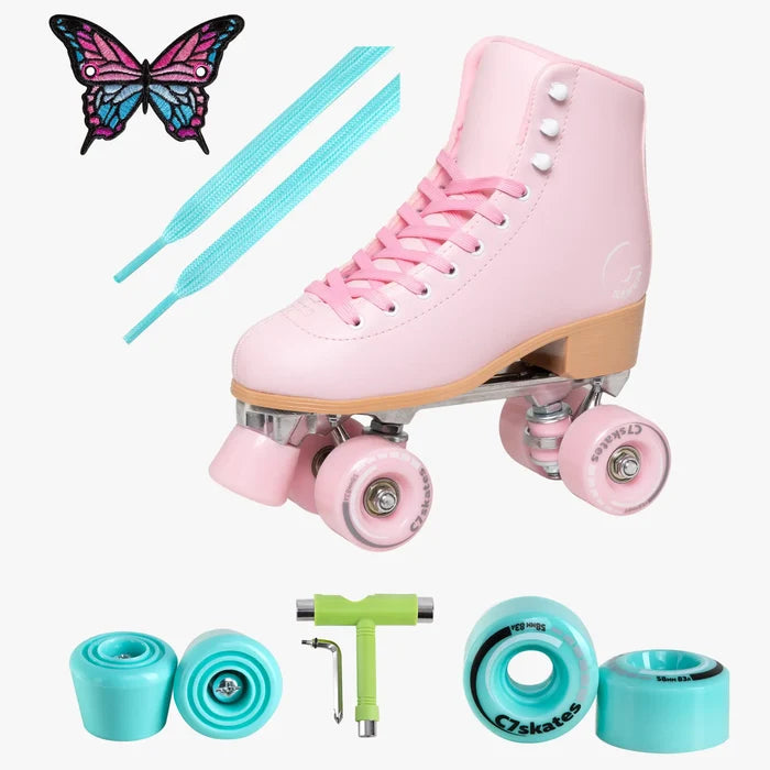 Pink roller skates with accessories on a white background