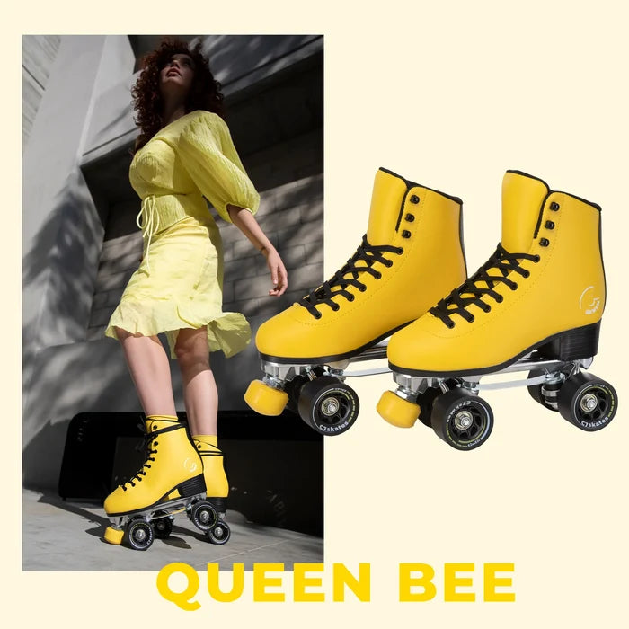 Yellow roller skates with 'QUEEN BEE' branding on a light background.