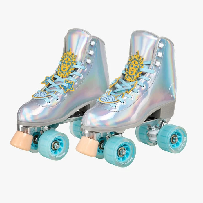 Iridescent roller skates with peach laces and charms on a white background