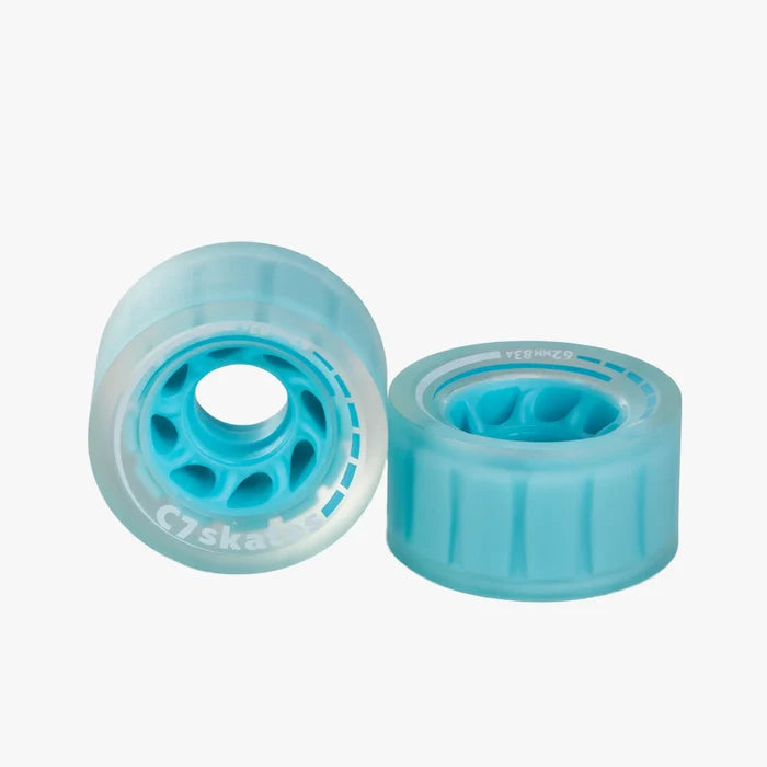 Two turquoise roller skates wheels on a white background