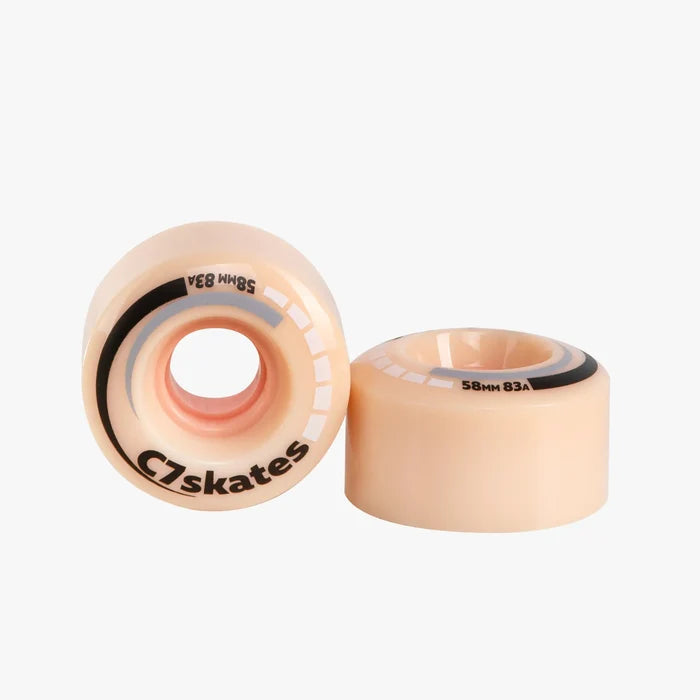 Two peach wheels with black bearings on a white background