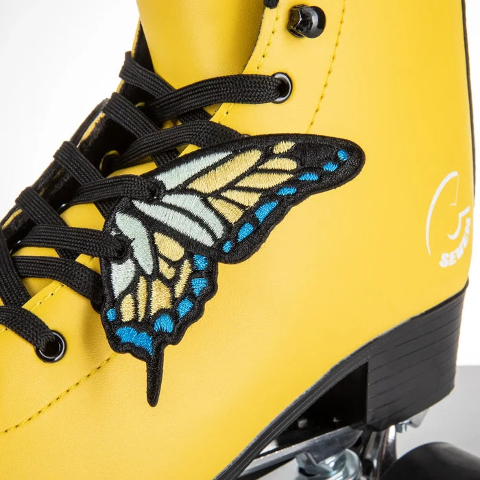 Yellow roller shoe with a butterfly patch and black laces on a white background