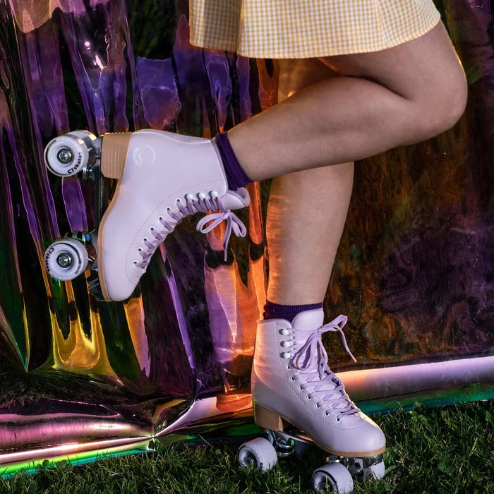 Person wearing white roller skates with a colorful background