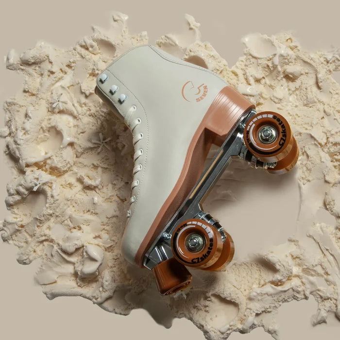 White roller skate with brown accents on a textured beige background