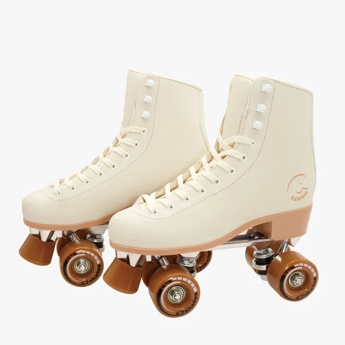 Pair of cream-colored roller skates with brown wheels on a white background