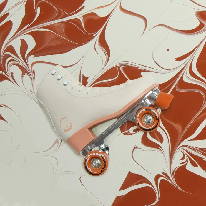 White roller skate with orange wheels on a marbled brown and white background