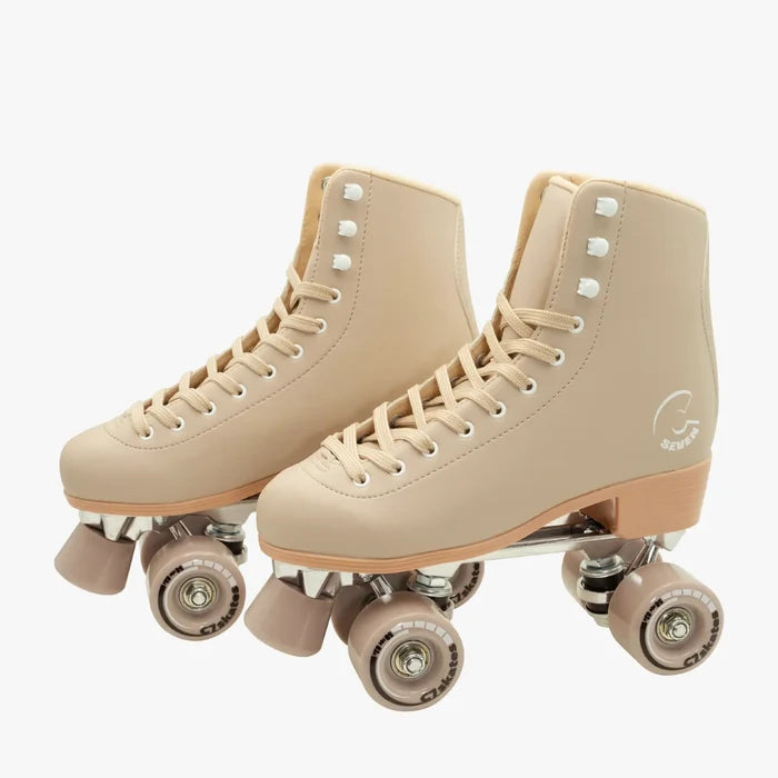 Pair of beige roller skates on a white background