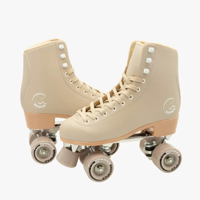 Pair of beige roller skates on a white background